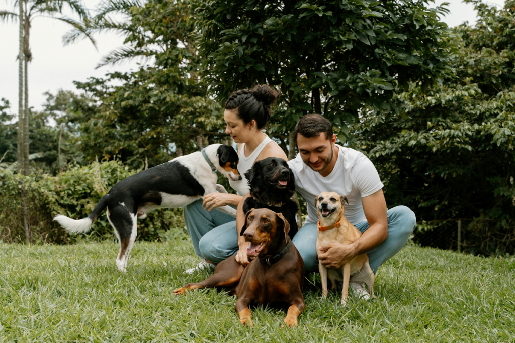 A Latino family with their dogs.