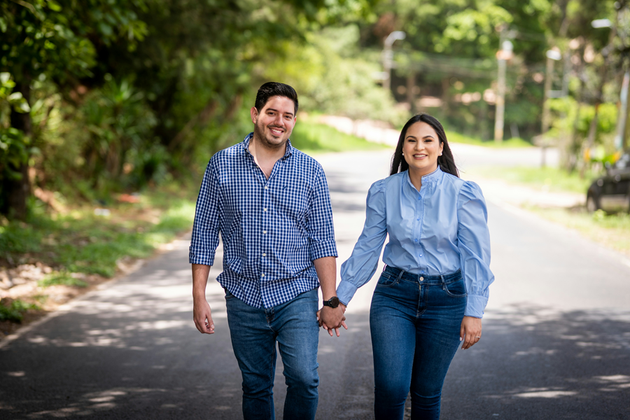 A smart latino money couple walks confidently.
